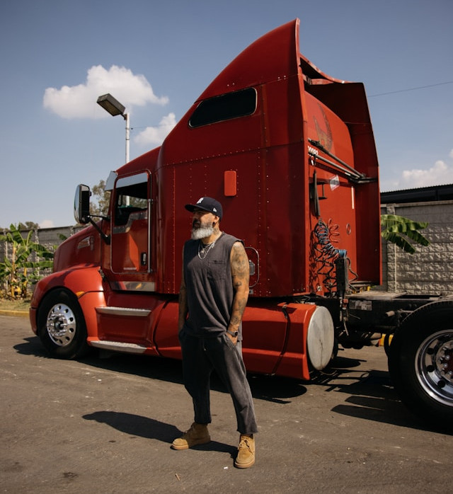 Red semi tractor truck with owner-operator