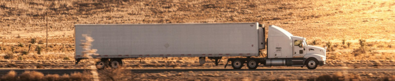 Semi Truck and Trailer drving down the highway